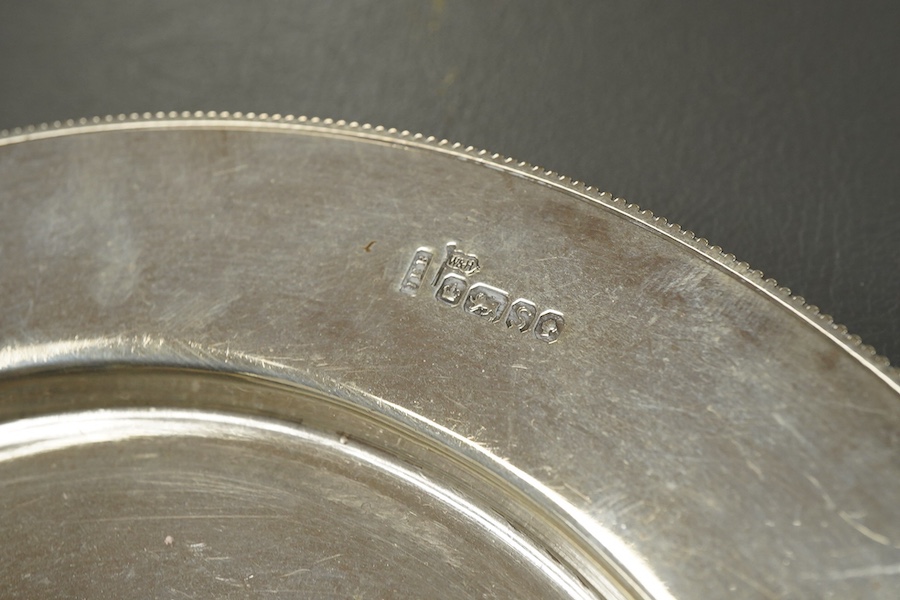 A Victorian silver side plate or stand, by John Edward Bingham (Walker & Hall), Sheffield, 1885, diameter 17.9cm, together with an early 20th century silver cream jug and sugar bowl by Barker Brothers and a Victorian pro